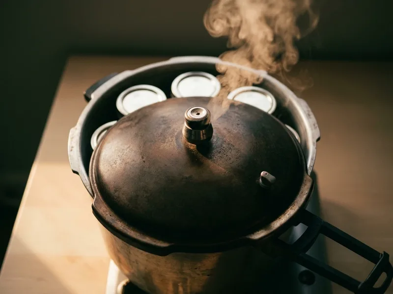 A stovetop pressure canner venting steam